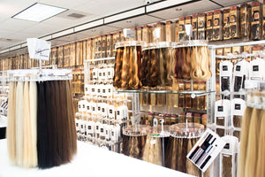 Display of different color hair extensions inside The Hair Shop store