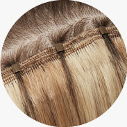 Close-up of One-Step Weft extensions applied on head