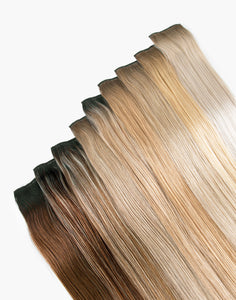 row of pro 7 clip-in® set bundle extensions in  a variety of colors
