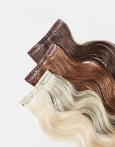 row of bundles of Skinny Clip-In extensions in a variety of colors