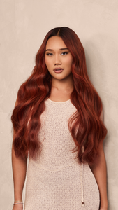 Portrait of a model showcasing HĪEW 07 - Refined Red hair extension.