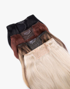 row of volume veil clip-in extensions in a variety of colors