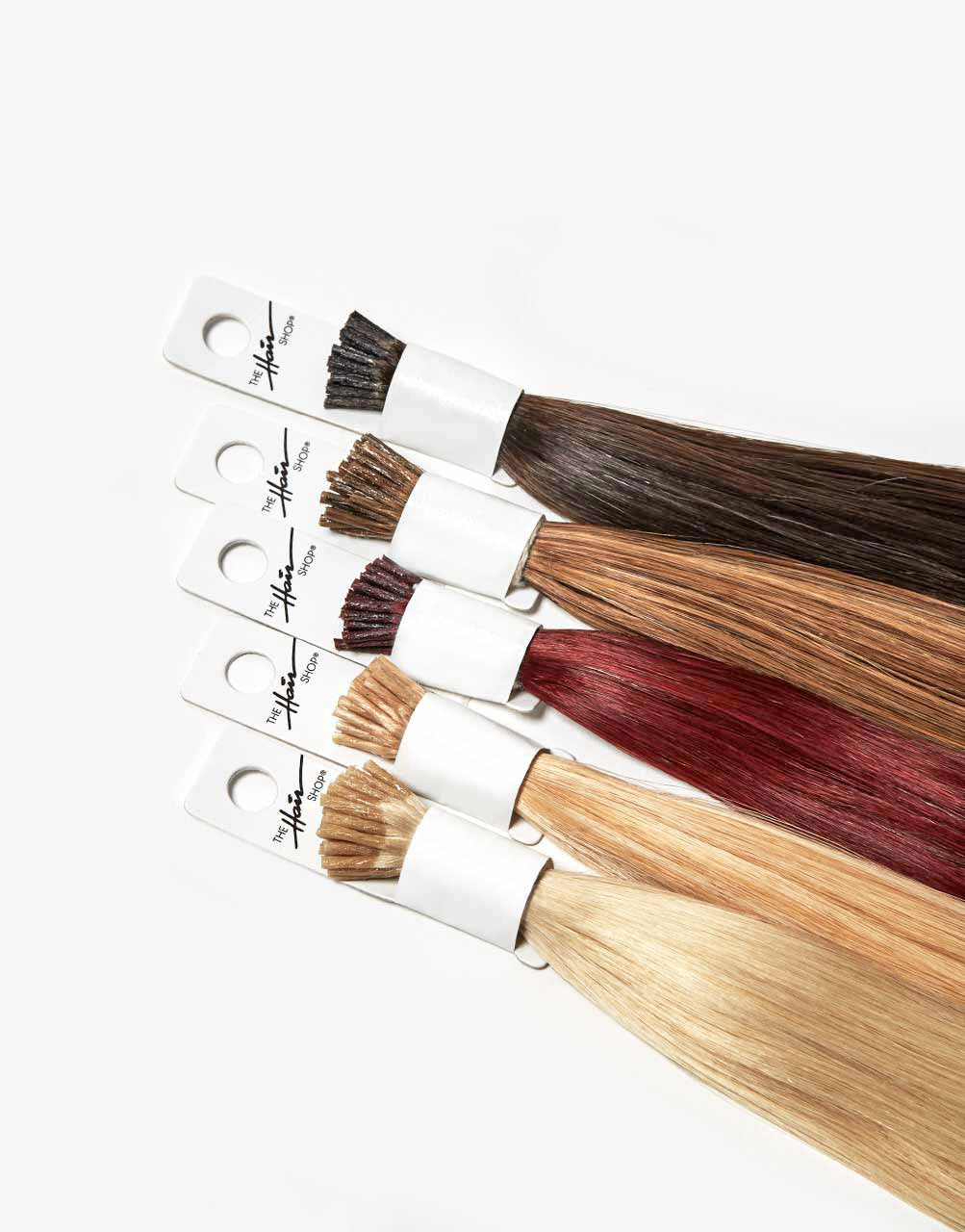 row of bundles of 808 I-tip extensions in a variety of colors
