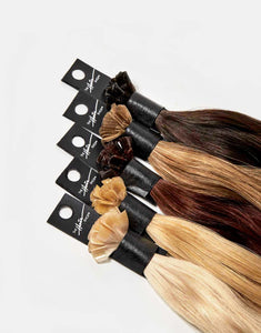 row of bundles of 707 exclusive keratip® extensions in a variety of colors